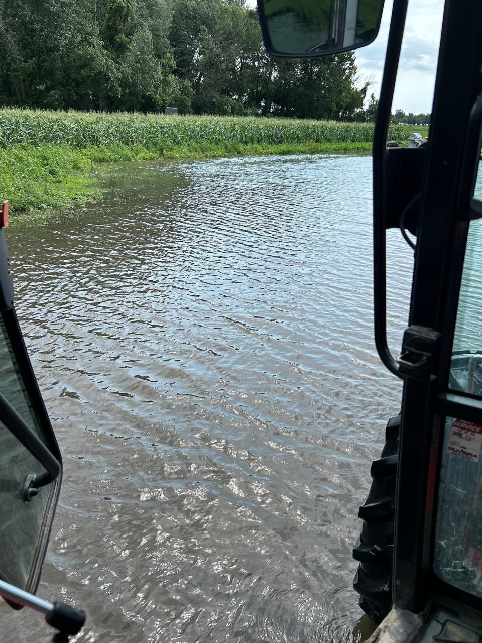 High waters levels in a flooded Essex County field are shown from inside a tractor.