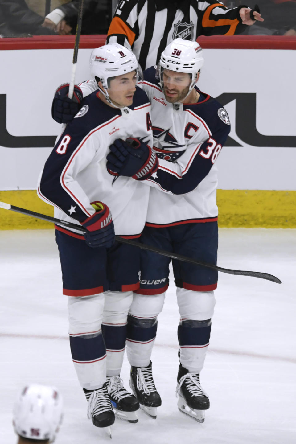 Columbus Blue Jackets' Boone Jenner (38) celebrates with Zach Werenski (8) after scoring a goal against the Chicago Blackhawks during the first period of an NHL hockey game Saturday, March 2, 2024, in Chicago. (AP Photo/Paul Beaty)