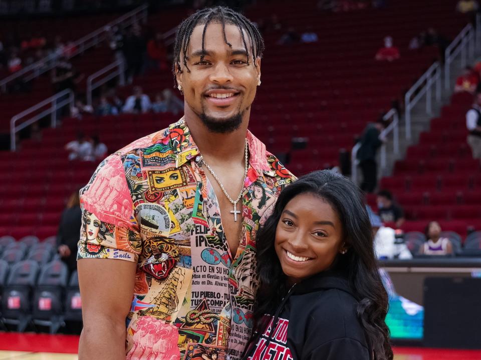 Simone Biles and Jonathan Owens attend a game between the Houston Rockets and the Los Angeles Lakers at Toyota Center on December 28, 2021