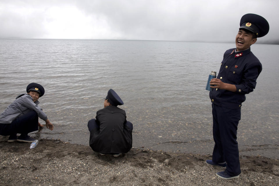 FILE - In this Aug. 18, 2018, file photo, North Korean railway workers enjoy an outing on the banks of Chon Lake in the caldera of Mount Paektu in North Korea. There is no more sacred a place in North Korea than Mount Paektu. The still active volcano, site of one the most violent eruptions in history, is considered to be the spiritual epicenter of the North Korean revolution. (AP Photo/Ng Han Guan, File)