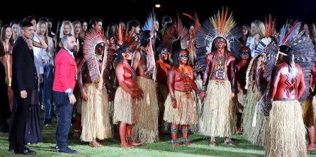 Founder of Cavalera, Alberto Hiar (2nd L) looks on after models presented creations from the Cavalera Summer 2016 Ready To Wear collection with indians of Yawanawa ethnicity during Sao Paulo Fashion Week in Sao Paulo April 13, 2015. REUTERS/Paulo Whitaker