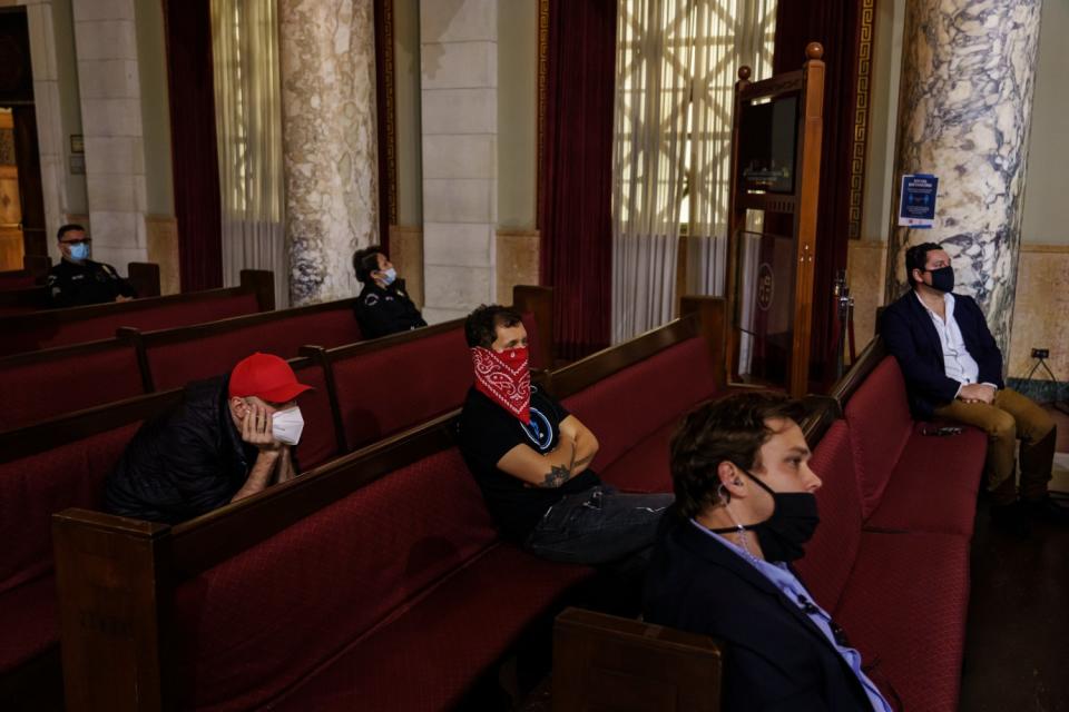 People watch as Los Angeles Mayor Eric Garcetti gives his annual 'State of the City' speech at City Hall in Los Angeles.