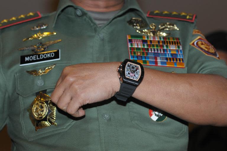 Indonesian military chief General Moeldoko displays his luxury watch to journalists in Jakarta which he claims is a fake, April 23, 2014