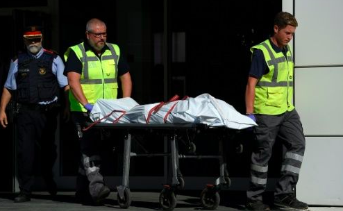 The body of a man who tried to attack a police station is carried out of the premises in Cornella near the northeastern Spanish city of Barcelona. Source: AFP