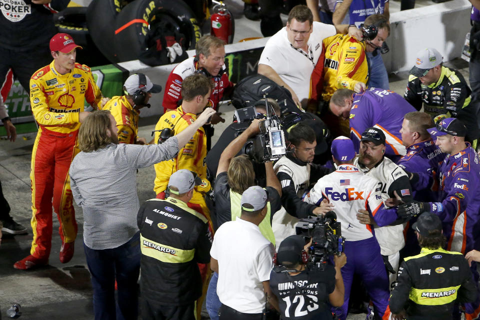 MARTINSVILLE, VIRGINIA - OCTOBER 27: Denny Hamlin, driver of the #11 FedEx Freight Toyota, Joey Logano, driver of the #22 Shell Pennzoil Ford, and their crews have an altercation on pit lane following the Monster Energy NASCAR Cup Series First Data 500 at Martinsville Speedway on October 27, 2019 in Martinsville, Virginia. (Photo by Brian Lawdermilk/Getty Images)