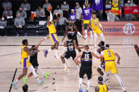 Los Angeles Lakers' LeBron James (23) shoots against the Denver Nuggets during the first half of an NBA conference final playoff basketball game Thursday, Sept. 24, 2020, in Lake Buena Vista, Fla. (AP Photo/Mark J. Terrill)