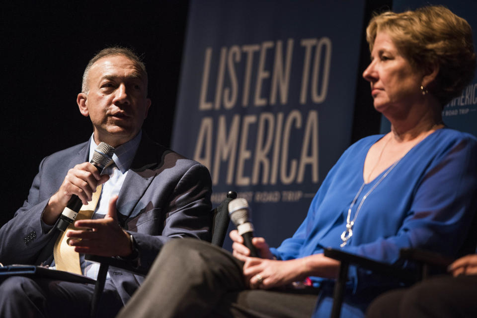 Mike Brumage speaks to the audience as fellow panelist Andrea Darr listens.