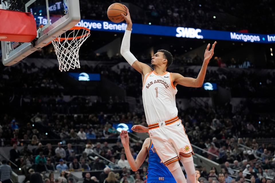 San Antonio Spurs center Victor Wembanyama (1) scores over Oklahoma City Thunder forward Chet Holmgren during the first half of an NBA basketball game in San Antonio, Wednesday, Jan. 24, 2024. (AP Photo/Eric Gay)