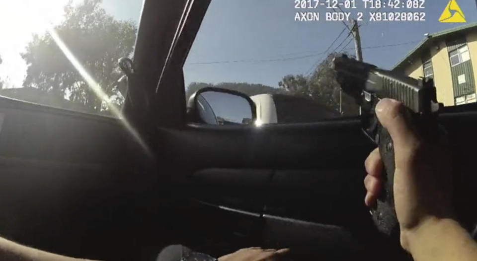 In a file image taken from a San Francisco Police Department officer's body camera video, an officer aims his weapon before the fatal shooting of Keita O’Neil in the Bayview neighborhood of San Francisco.