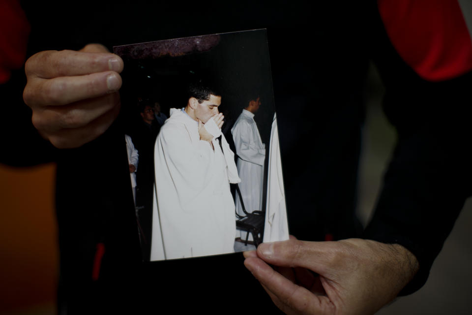 Andres Gioeni shows a photograph of his ordination ceremony to become a priest in 2000, after he got home from the bishopric where he started the process of apostasy in Buenos Aires, Argentina, Wednesday, March 17, 2021. Gioeni, who left the priesthood in 2021 and married his boyfriend in 2014, said he has decided to formally leave the church after the Vatican decreed that the Catholic Church cannot bless same-sex unions since God ‘cannot bless sin.’ (AP Photo/Natacha Pisarenko)