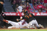 Los Angeles Angels' Anthony Rendon (6) is safe at home to scored ahead of a tag by Baltimore Orioles catcher Pedro Severino (28) during the third inning of a baseball game Friday, July 2, 2021, in Anaheim. (AP Photo/Ashley Landis)