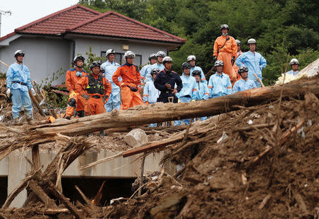 Rescue workers conduct search and rescue operations at a landslide site caused by heavy rain in Kumano Town, Hiroshima Prefecture, western Japan, July 11, 2018. REUTERS/Issei Kato