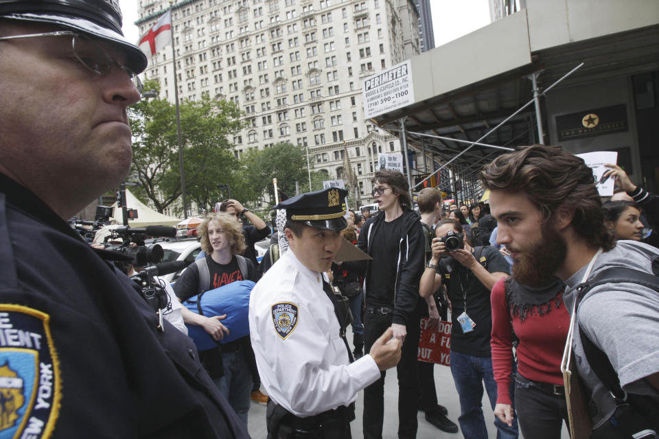 FILE - In this Sept. 17, 2011 file photo, a New York City Police supervisor, center, addresses a member of the crowd as demonstrators affiliated with the Occupy Wall Street movement gather to call for the occupation of Wall Street in New York. Monday, Oct. 17, 2012 marks the one-year anniversary of the Occupy Wall Street movement. (AP Photo/Frank Franklin II, File)