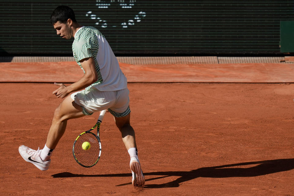 Spain's Carlos Alcaraz plays a tweener against Italy's Lorenzo Musetti during their fourth round match of the French Open tennis tournament at the Roland Garros stadium in Paris, Sunday, June 4, 2023. (AP Photo/Thibault Camus)