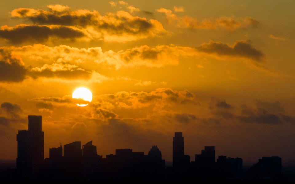 The sun rises over downtown Austin on another hot day on June 30, 2023.