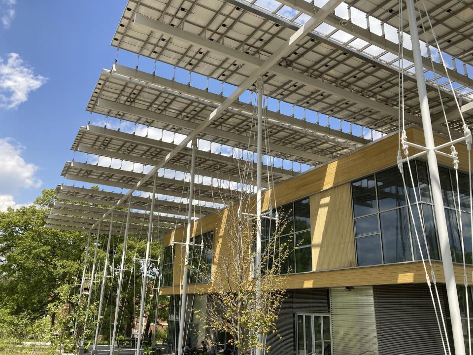 A solar canopy shields Georgia Tech's Kendeda Building from the sun as it generates electricity on Tuesday, April 20, 2021, in Atlanta. The $25 million structure has been certified as a living building, meaning it helps the environment more than it hurts it. (AP Photo/Jeff Amy)