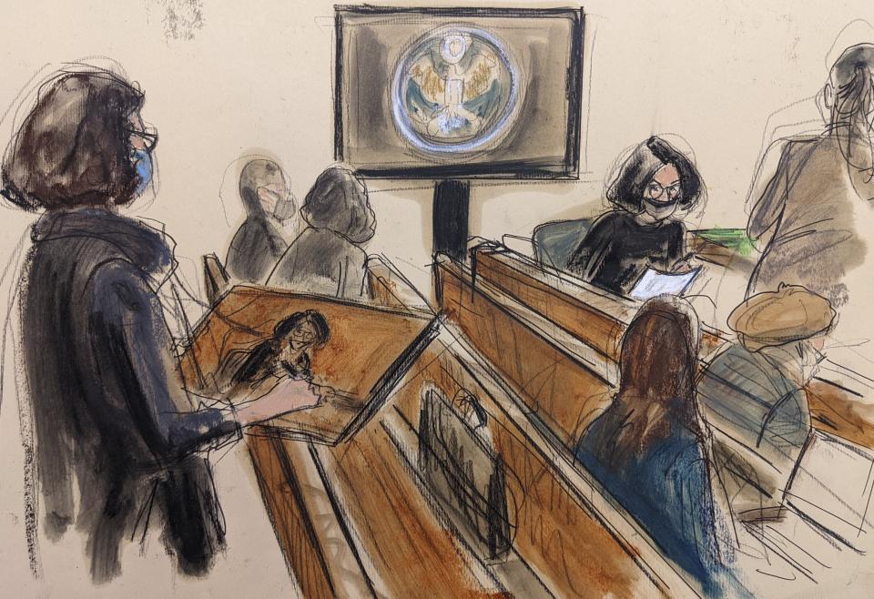 FILE - In this courtroom sketch, Ghislaine Maxwell, seated second from right, draws a courtroom artist, standing far left, during a courtroom break in her sex-abuse trial, Tuesday Dec. 7, 2021, in New York. (Elizabeth Williams via AP)