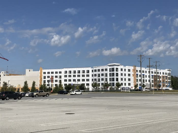 A large apartment building under construction adjacent to Exton Square Mall