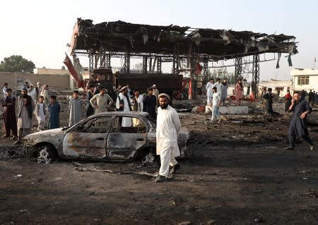 Afghan residents inspect the site of a blast in Kabul