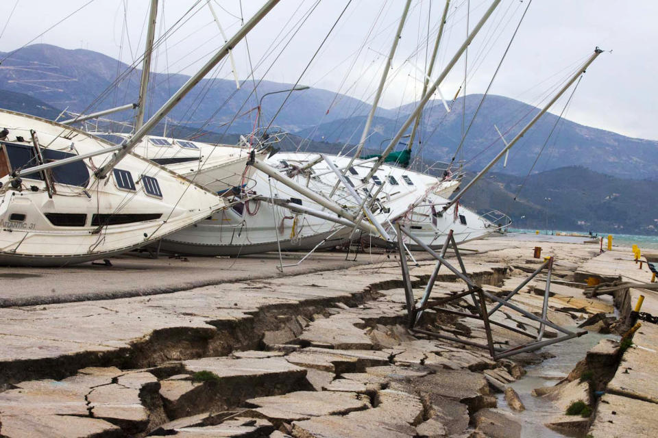 Yachts are seen knocked off their stands at a damaged dock after an earthquake in Lixouri on the island of Kefalonia, western Greece on Monday, Feb. 3, 2014. A strong earthquake with a preliminary magnitude between 5.7 and 6.1 hit the western Greek island of Kefalonia before dawn Monday, sending scared residents into the streets just over a week after a similar quake damaged hundreds of buildings, reviving memories of a disaster in the 1950s. (AP Photo)