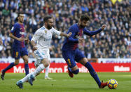 <p>Barcelona’s Gerard Pique, right, vies for the ball with Real Madrid’s Daniel Carvajal during the Spanish La Liga soccer match between Real Madrid and Barcelona at the Santiago Bernabeu stadium in Madrid, Spain, Saturday, Dec. 23, 2017. (AP Photo/Francisco Seco) </p>