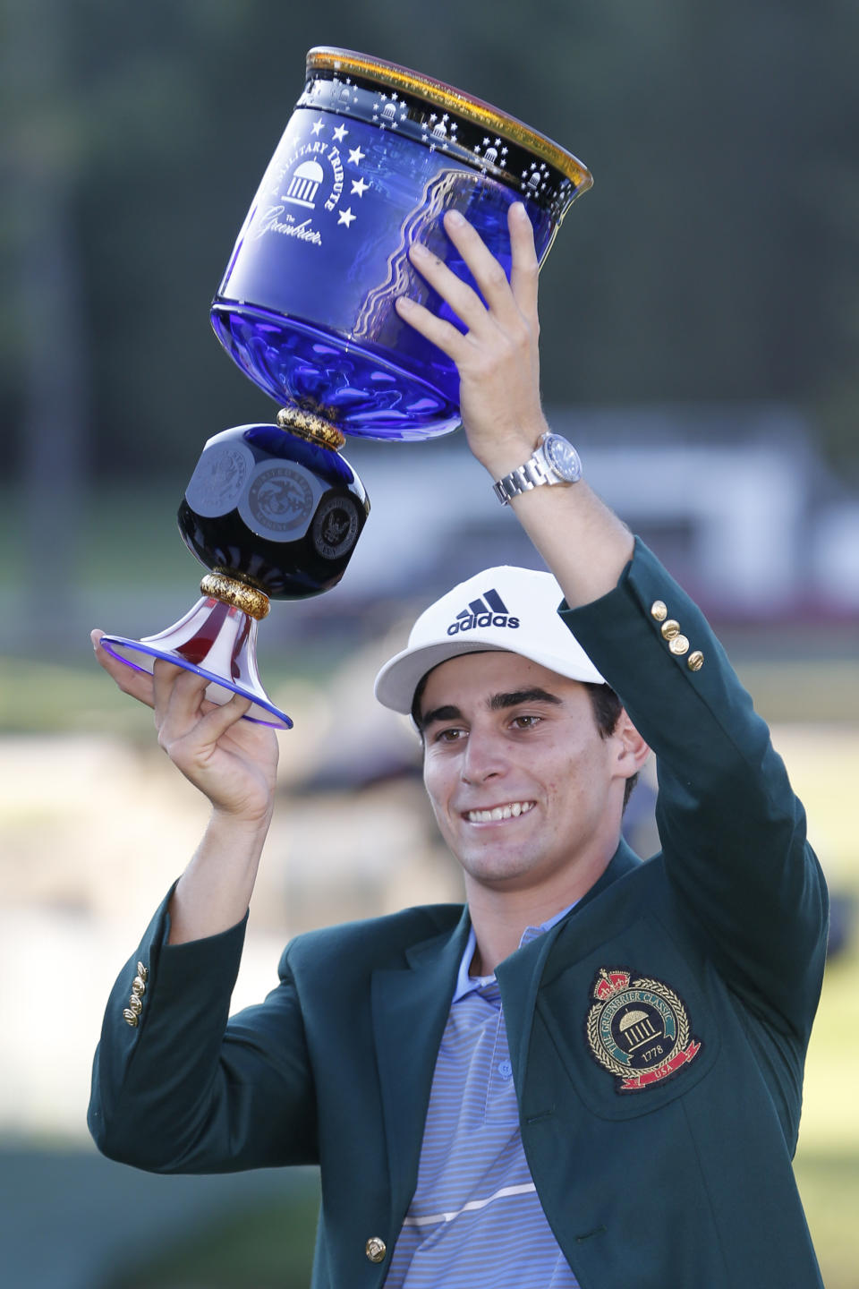 Joaquin Niemann, of Chile, holds the winners trophy as he celebrates winning the A Military Tribute at The Greenbrier golf tournament in White Sulphur Springs, W.Va., Sunday, Sept. 15, 2019. Niemann finished the tournament at 21-under-par. (AP Photo/Steve Helber)