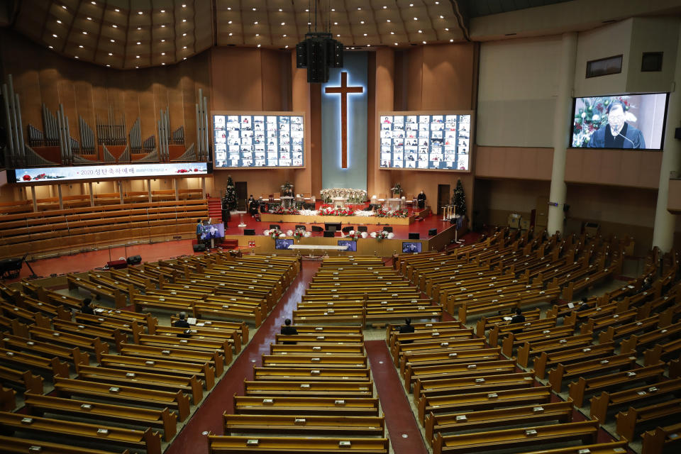 Christians on the screen attend an online Christmas service for social distancing and a precaution against the coronavirus at the Yoido Full Gospel Church in Seoul, South Korea, Friday, Dec. 25, 2020. (AP Photo/Lee Jin-man)