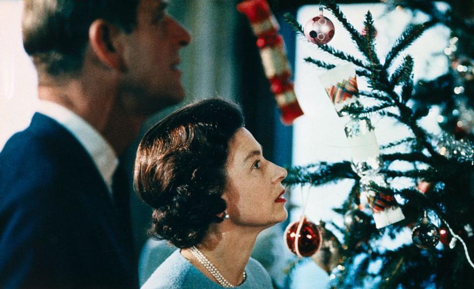 original caption christmas at windsor castle is shown here with queen elizabeth ii and prince philip shown putting finishing touches to christmas tree, in a photo made recently during the filming of the joint itv bbc film documentary, the royal family