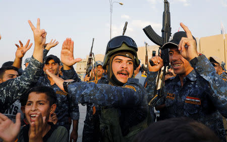 Members of Iraqi Federal Police dance and sing as they celebrate victory of military operations against the Islamic State militants in West Mosul, Iraq July 2, 2017. REUTERS/Erik De Castro