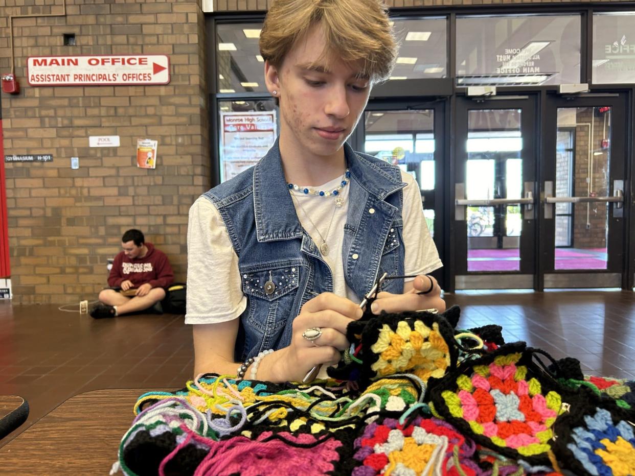 Monroe High School senior Brandon Miller is shown crocheting his prom outfit at school.