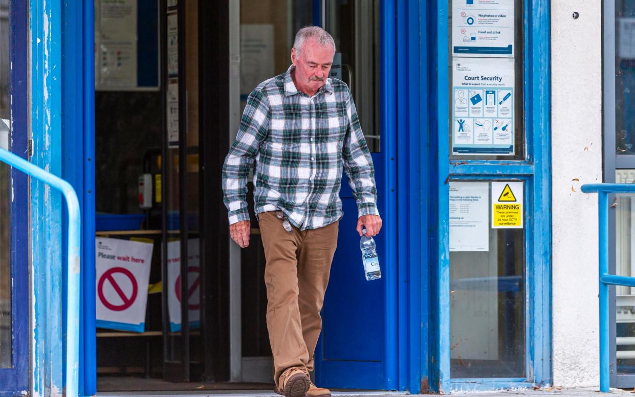 Peter Dick leaves Poole magistrates' court, where he entered a not-guilty plea