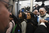 State employees enter their workplace after they were temporarily prevented from entering their workplace due to an anti-government protest in support of workers who were laid off as part of state economic downsizing measures, in Buenos Aires, Argentina, Wednesday, April 3, 2024. According to the State Workers Association, more than 11 thousand dismissals of state employees have been carried out by Javier Milei’s government. (AP Photo/Gustavo Garello)