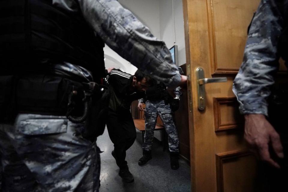 A man suspected of taking part in the attack at a concert hall that killed 143 people, the deadliest attack in Europe to have been claimed by the Islamic State jihadist group, is escorted by Russian law enforcement officers prior to his pre-trial detention hearing at the Basmanny District Court in Moscow on March 24, 2024. (Tatyana Makeyeva/AFP via Getty Images)