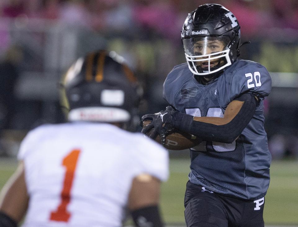 Perry running back Christian Ivanic looks for running room against Green defender Antonio Martin in the second half, Friday, Oct. 6, 2023.