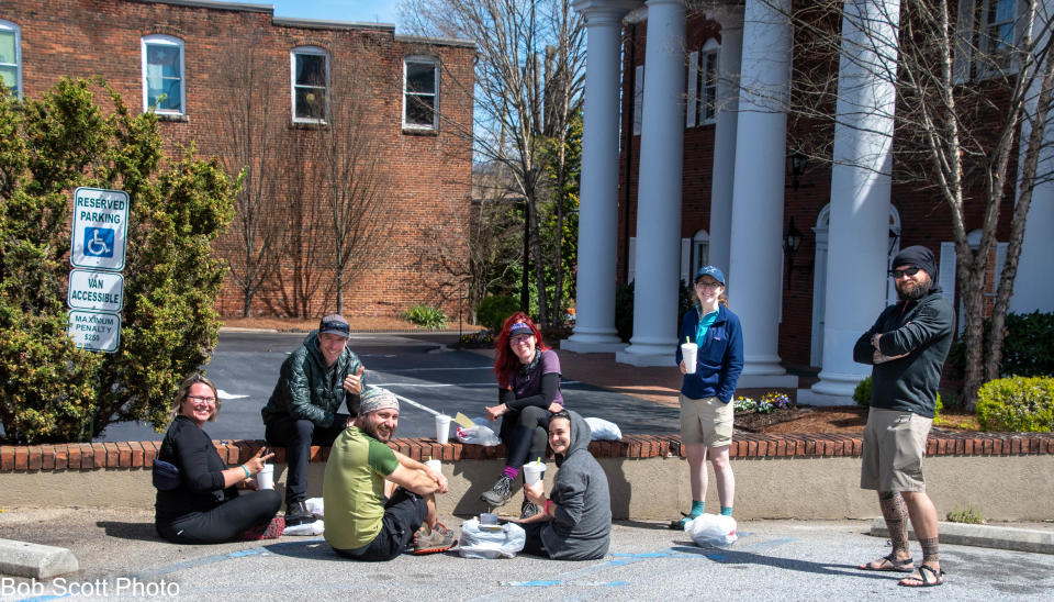 Appalachian Trail thru-hikers get take-out from the Motor Company on Main Street in Franklin March 30 and eat in a parking lot. The Appalachian Trail Conservancy has urged thru-hikers to postpone their trips and for no one to day hike the trail to help slow the spread of coronavirus.