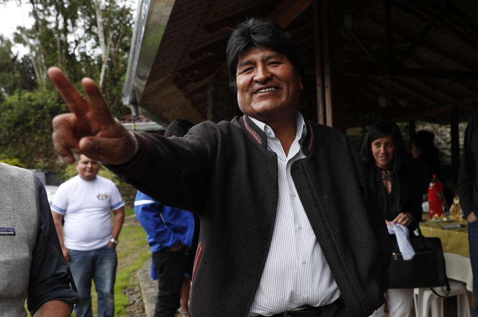 Bolivia's President Evo Morales waves to members of the press as he visits a trout farm where he stopped to eat in Incachaca, Bolivia, Saturday, Oct. 19, 2019. Morales is seeking a fourth term in Sunday's general elections. (AP Photo/Juan Karita)