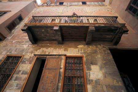 A man stands in the balcony of an Ottoman-era house in Darb al-Ahmar neighbourhood in Cairo