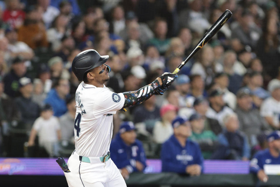 Seattle Mariners' Julio Rodríguez watches his two-run home run off Texas Rangers starting pitcher Nathan Eovaldi during the third inning of a baseball game Saturday, June 15, 2024, in Seattle. (AP Photo/Jason Redmond)