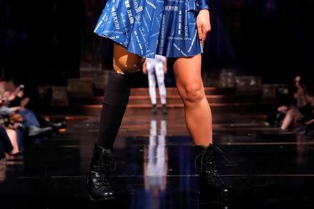 A model with a prosthetic leg presents a creation from the "21 Reasons Why By Madeline Stuart" label designed by Australian model and designer Madeline Stuart, who has Down syndrome, during New York Fashion Week in Manhattan, New York, U.S., February 12, 2017. REUTERS/Andrew Kelly