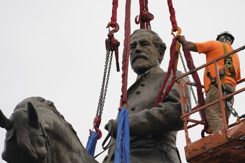 Crews work to remove one of the country's largest remaining monuments to the Confederacy, a towering statue of Confederate General Robert E. Lee on Monument Avenue, Wednesday, Sept. 8, 2021, in Richmond, Va. (AP Photo/Steve Helber, Pool)