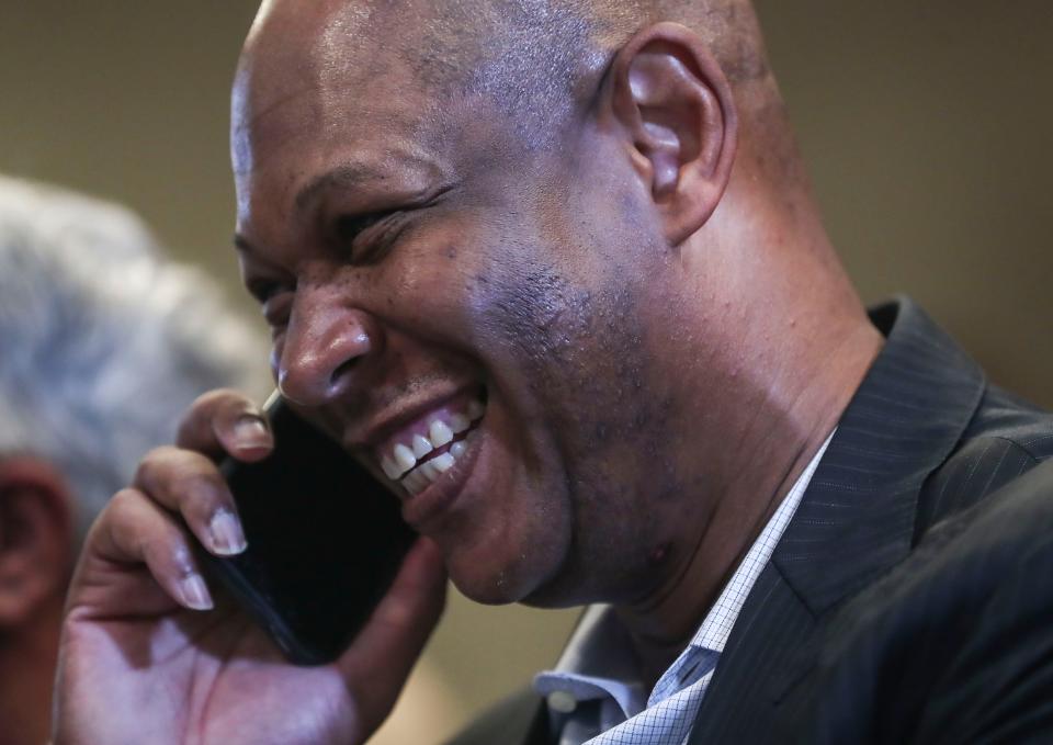 UofL men's basketball coach Kenny Payne smiles while answering a call before the formal introduction of Josh Heird as Louisville's new athletic director after being endorsed at the UofL Athletic Association meeting Friday morning. June 3, 2022