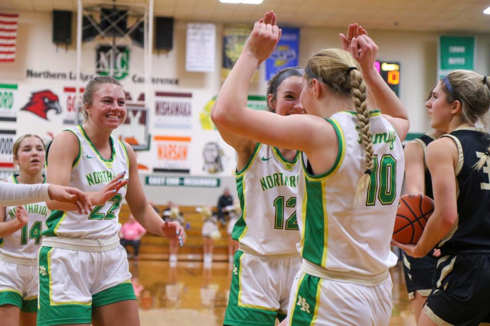 Northridge teammates celebrate with Morgan Cross (10) after a play during the Penn vs. Northridge girls basketball sectional game Tuesday, Jan. 31, 2023 at Concord High School.