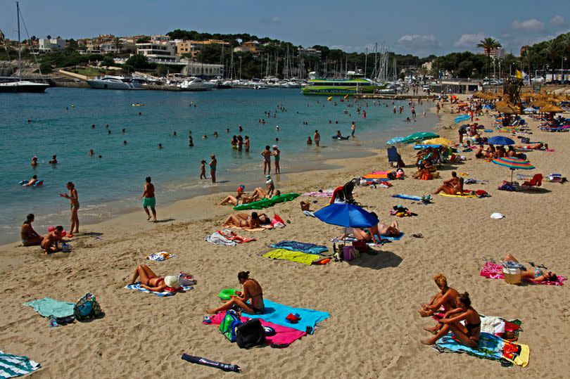 People on the beach of Porto Cristo, in Majorca, in pure sunshine