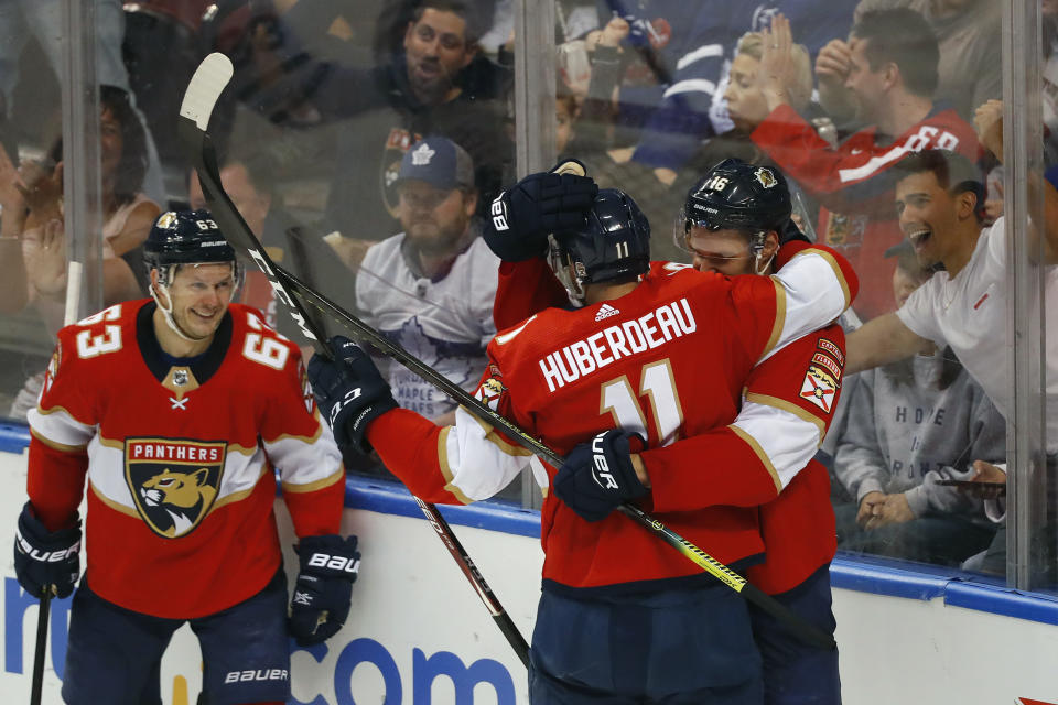 Florida Panthers left wing Jonathan Huberdeau (11) is congratulated by center Aleksander Barkov (16) and right wing Evgenii Dadonov (63) after he scored a goal during the second period of an NHL hockey game against the Toronto Maple Leafs, Sunday, Jan. 12, 2020, in Sunrise, Fla. (AP Photo/Wilfredo Lee)