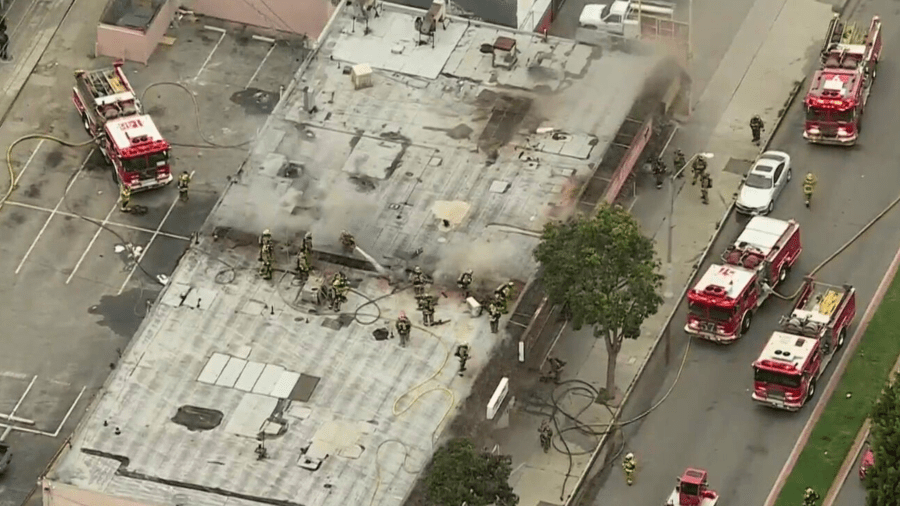 Firefighters respond to a burning strip mall in Lynwood on April 25, 2024.