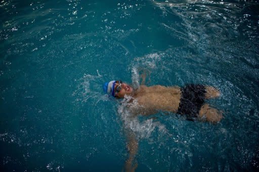 Afghan amputee Malek Mohammad trains in a swimming pool in Kabul on April 13, 2012. Malek is one of tens of thousands of Afghan amputees, victims of three decades of war -- 10 years of fighting against Soviet troops in the 1980s, civil war and the current Taliban insurgency -- that have made Afghanistan one of the most heavily mined countries in the world