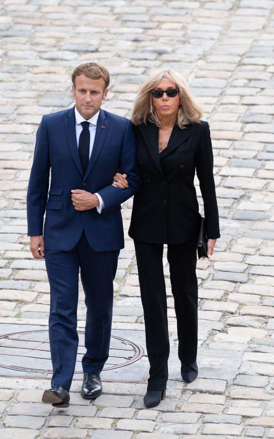 France’s President Emmanuel Macron (L) and his wife Brigitte Macron arrive to attend the national tribute ceremony to late French actor Jean-Paul Belmondo at the Hotel des Invalides monument. - Credit: Jacques WITT/SIPA