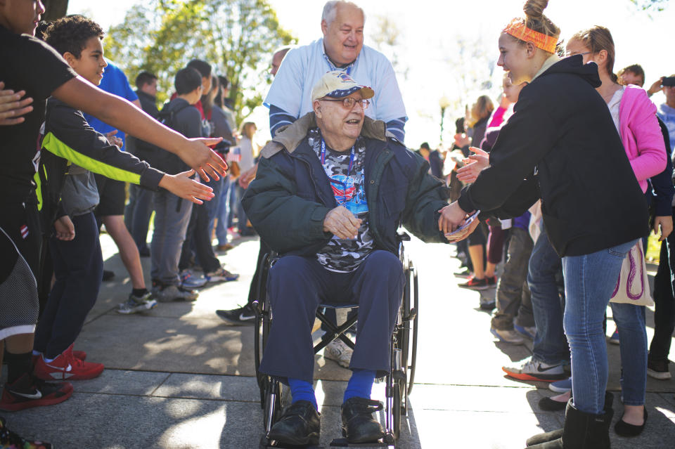 Anthony Petruzzi, 92, a veteran of World War II, Korea, and Vietnam is greeted as he arrives with an Honor Fight group from Kansas City, Missouri, at the WWII Memorial on Veteran's Day.