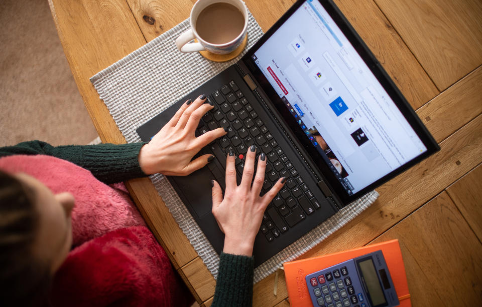 A woman using a laptop on a dining room table set up as a remote office to work from home. Workers told to self-isolate due to coronavirus will receive sick pay from day one, the Prime Minister has announced, as England's Chief Medical Officer warned that a UK epidemic is now "likely". PA Photo. Picture date: Wednesday March 4, 2020. See PA story HEALTH Coronavirus. Photo credit should read: Joe Giddens/PA Wire