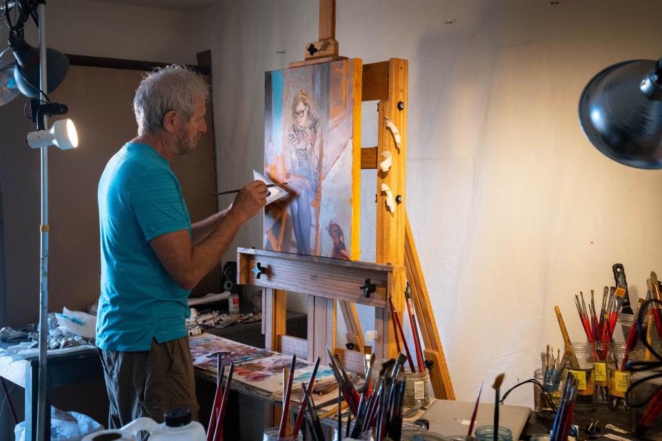 David FeBland works on a painting on May 6, 2022, in his home studio in Phoenix.